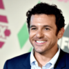 fred savage poses in front of a fox banner