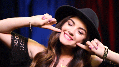 lucy hale wearing a cute hat and smiling
