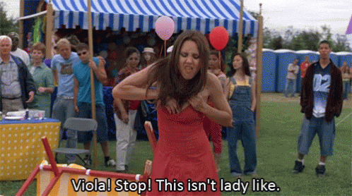 actress amanda bynes as viola pulls popcorn out of the top of her dress