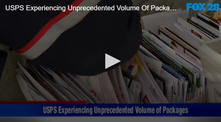 white bin filled with mail and arm reaching over the top of it