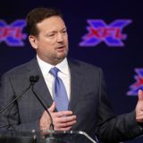 coach bob stoops speaking at a press conference for the xfl