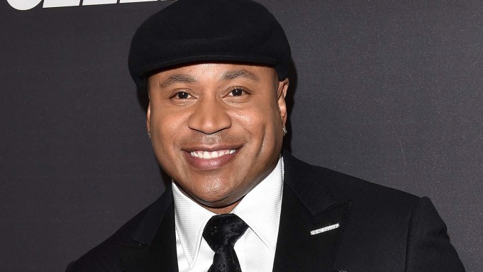 actor and music star ll cool j dressed in a black suit with a white shirt and a black tie and a black hat