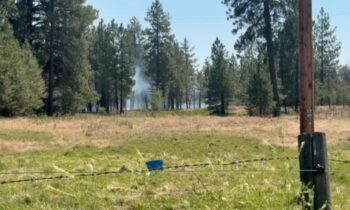 Firefighters working to contain a 10 acre fire off Cheney-Spokane road